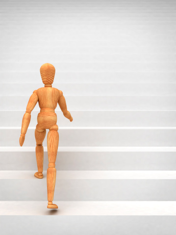 Mannequin climbing stairs (isolated on white background)