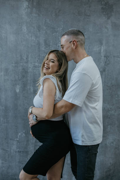 istock Affectionate husband embracing pregnant wife 1573696788