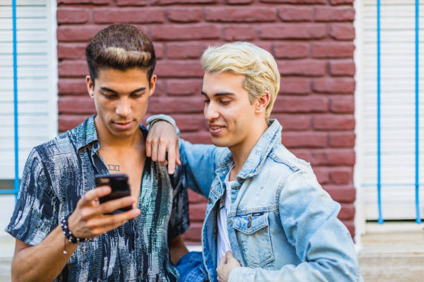 istock Gay couple walking around 1573700582