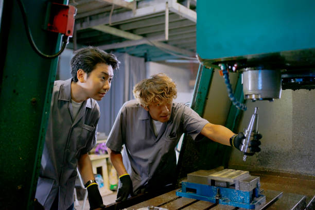 istock Blue collar workers are working at metal work factory. 1573704634