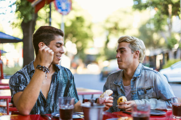 istock Gay couple having a conversation in a cafe 1573711558