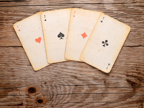 Old playing cards on wooden background