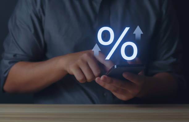 istock Simulated interest rate increase with percentage symbol in hand 1573721587