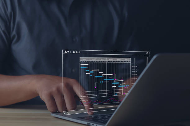 istock Businessman pointing to work project and improving work by planning progress and diagrams on computer screen 1573722646