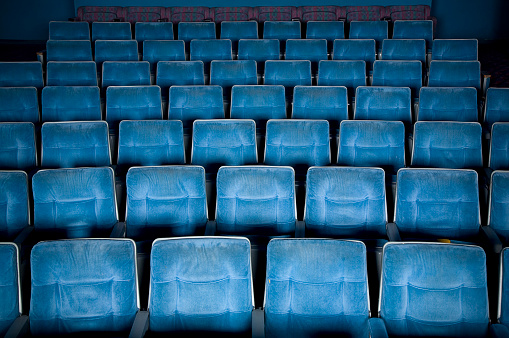 Many new white empty stadium seats close up