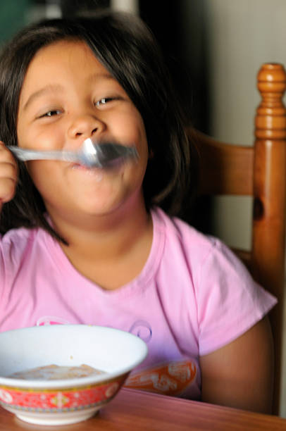 istock Preschooler eating breakfast with motion blur 157373084