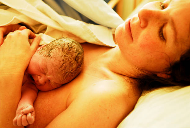 istock Newborn Baby Lying on Mother 157373190