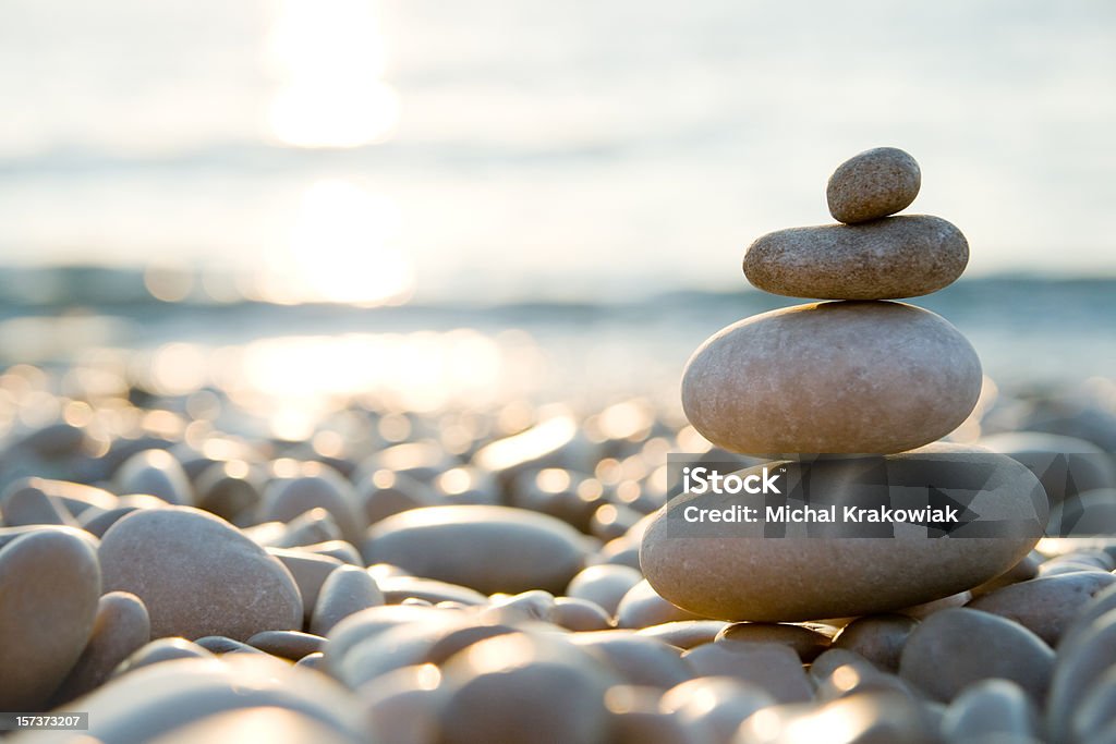 Balanced stones on a pebble beach during sunset. Stone composition on the beach. Balance Stock Photo