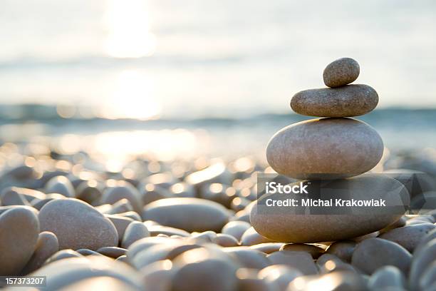 Balanced Stones On A Pebble Beach During Sunset Stock Photo - Download Image Now - Balance, Stone - Object, Zen-like