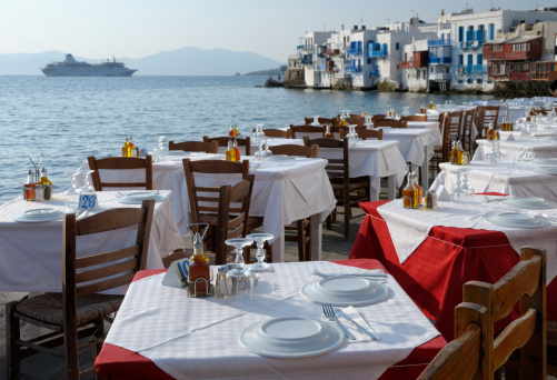 Restaurant Tables and Venetian houses in Mykonos, Greece.
