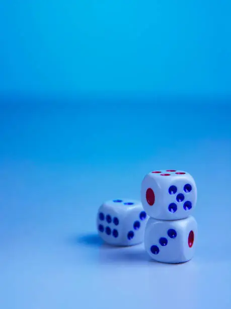 Photo of three dices on blue background