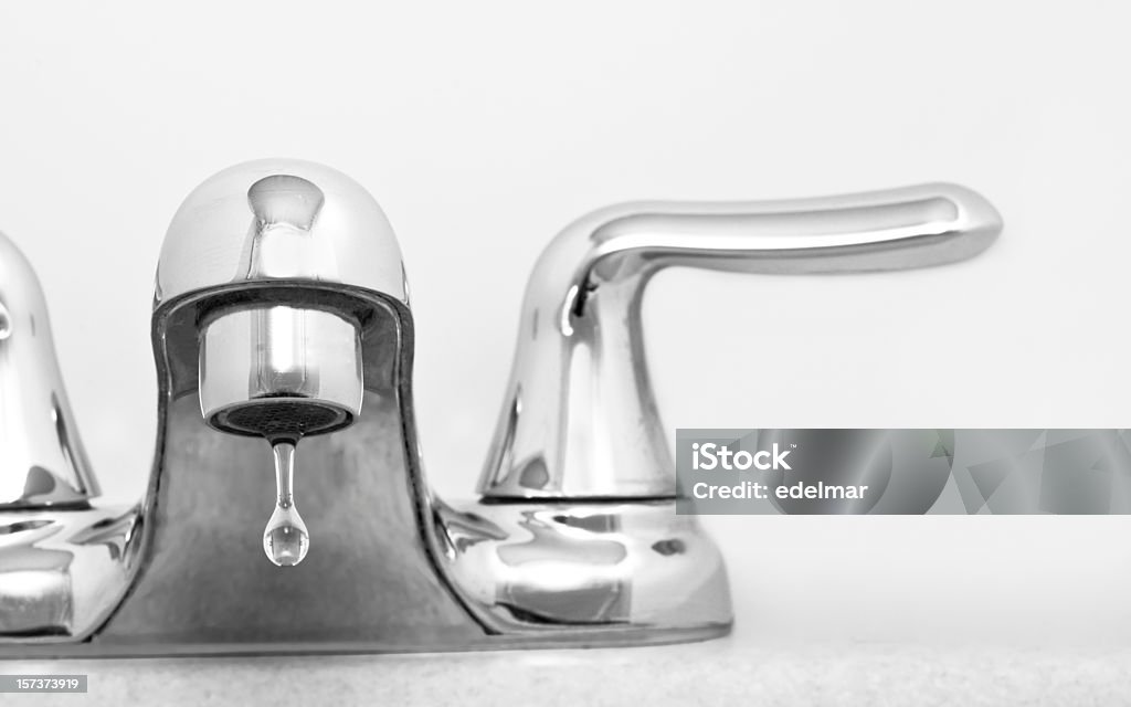 Close up of stainless steel faucet dripping water H2 Whoaa! Did you see the water bill? Faucet Stock Photo