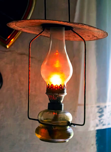 a vintage lamp hangs in an old house. - oil lantern imagens e fotografias de stock