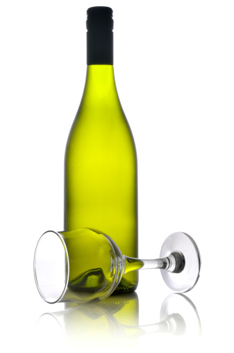 Full bottle of white wine with empty glass, on white background