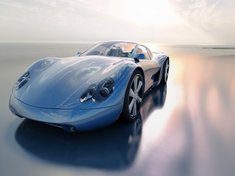 A blue sports car on a beach.  Car is my own design. Very high resolution 3D render.