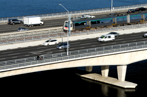 Movement blur on cars and the train as they cross the narrows bridge in Perth, Western Australia.