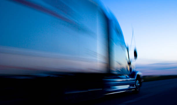 camião de velocidade para baixo no freeway pelo anoitecer - highway truck road driving imagens e fotografias de stock