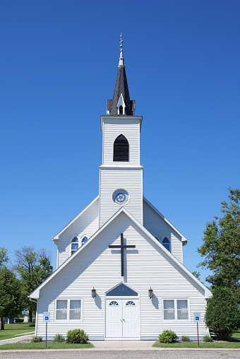 Rural vintage white church.  Frontal view.  Location: North Dakota, USA.