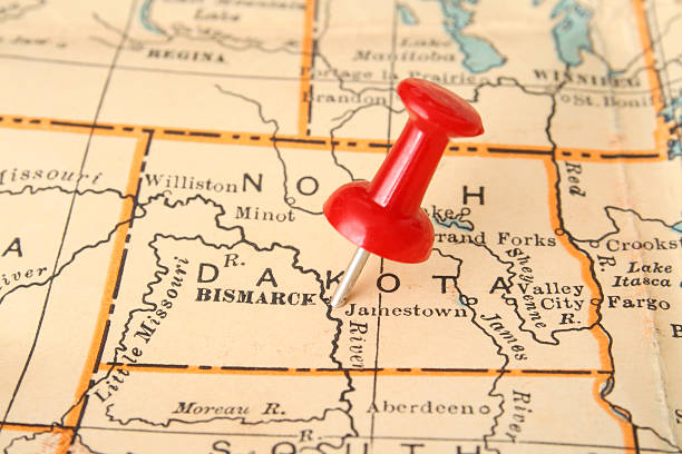 Bismarck Pushpin pointing Bismarck city, North Dakota state capital, over more than fifty years old map bismarck on a map stock pictures, royalty-free photos & images