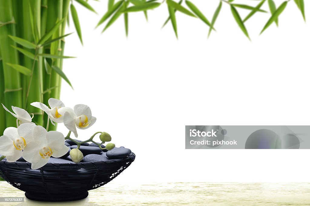 Tropical Beauty Spa Stones with Orchids and Bamboo on White. Feng Shui Stock Photo