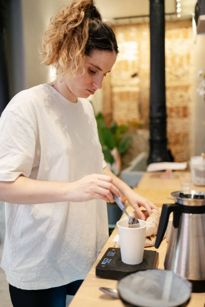 istock Young barista weighing coffee 1573753814