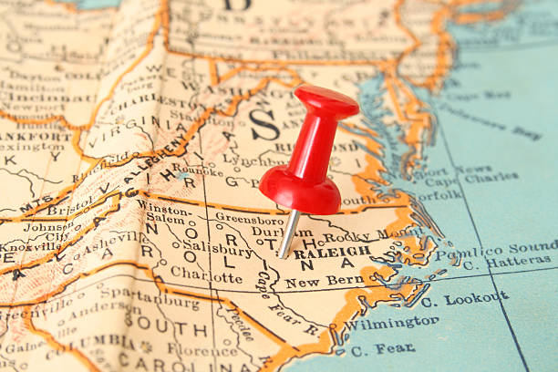 Raleigh Pushpin pointing Raleigh city, North Carolina state capital, over more than fifty years old map state of north carolina map stock pictures, royalty-free photos & images