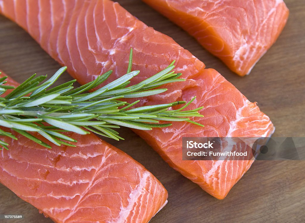 Fresh Salmon Meat Fish, Raw Seafood Fillets & Rosemary Herb Background  Above Stock Photo