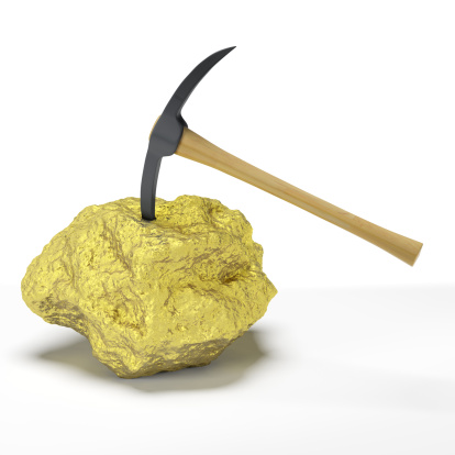 A large solid gold nugget with an embedded pick axe. Very high resolution 3D render.