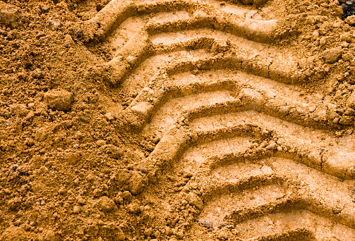 Imprint in the soil from heavy agricultural machinery.