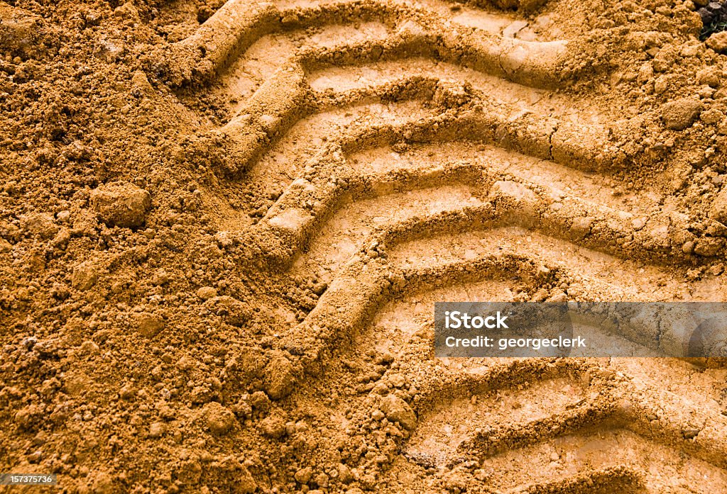 Agricultural Tyre Track Imprint in the soil from heavy agricultural machinery. Construction Industry Stock Photo