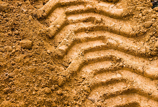 Agricultural Tyre Track Imprint in the soil from heavy agricultural machinery. impact photos stock pictures, royalty-free photos & images