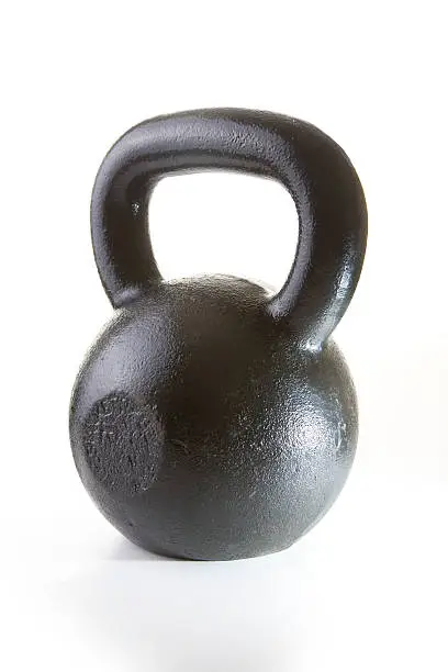 A 35lb kettlebell - a piece of weight training equipment - isolated on white.