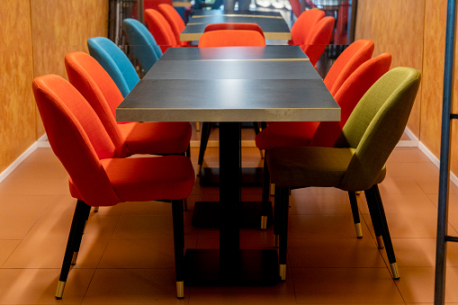 colored chairs arranged neatly around a table
