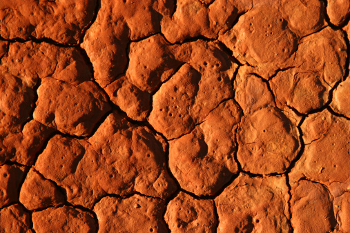 Old mud wall plaster with cracks close up