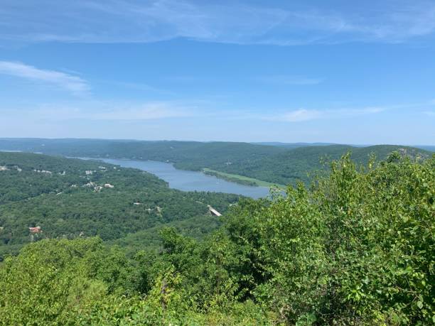istock Scenic landscape featuring a tranquil river surrounded by lush greenery. Bear Mountain, USA. 1573769915