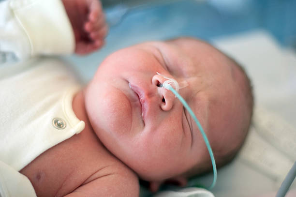 istock Day old baby head and shoulders intensive care 157377055