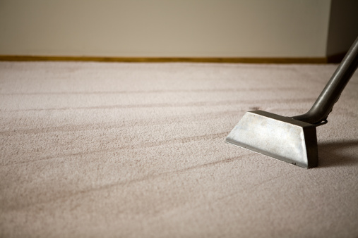 Vacuum cleaner on white carpet. Cleaning and domestic life image. Blank white background for massages.