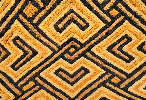 Detail of a Kasai velvet tapestry, hand-woven by the Kuba tribe people of the Kasai district of the Democratic Republic of Congo (Zaire).These tapestries with geometric designs and earth tones are woven in raised relief and made of palm leaf fibers or raffia.