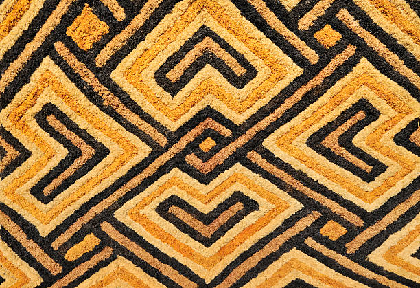 Detail of African Kasai velvet tapestry woven by Kuba tribe Detail of a Kasai velvet tapestry, hand-woven by the Kuba tribe people of the Kasai district of the Democratic Republic of Congo (Zaire).These tapestries with geometric designs and earth tones are woven in raised relief and made of palm leaf fibers or raffia. african tribe stock pictures, royalty-free photos & images