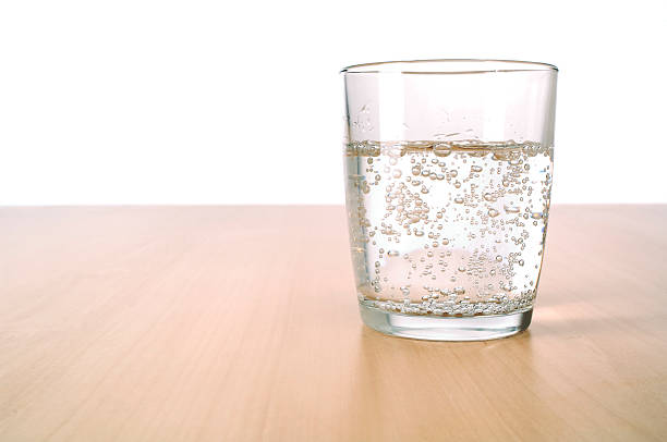 Glass of sparkling water on table  carbonated water photos stock pictures, royalty-free photos & images