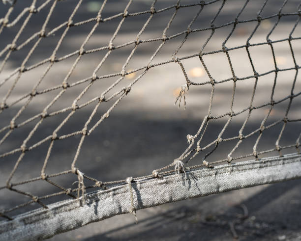 istock Old tennis net with holes 1573777913