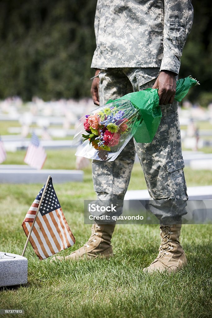 Army Soldier en Military Cemetery Grave con un ramo de flores, Copyspace - Foto de stock de Bandera libre de derechos