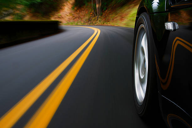 istock A black sports car driving around a curve 157377896