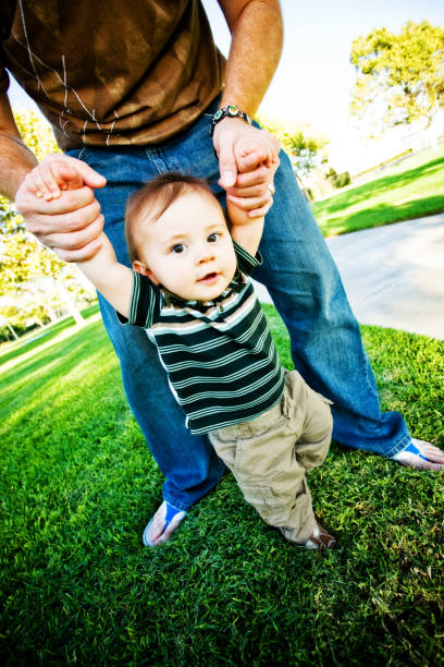 istock cute baby boy learning to walk 157378162
