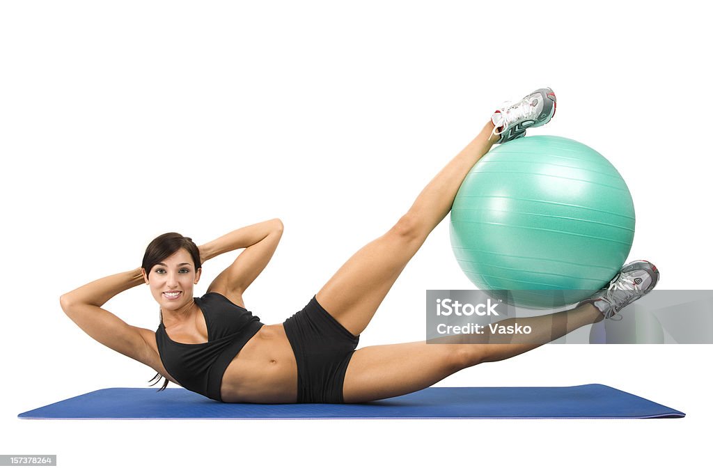 Side Crunches Picture of a woman working out with an exercise ball.    20-24 Years Stock Photo