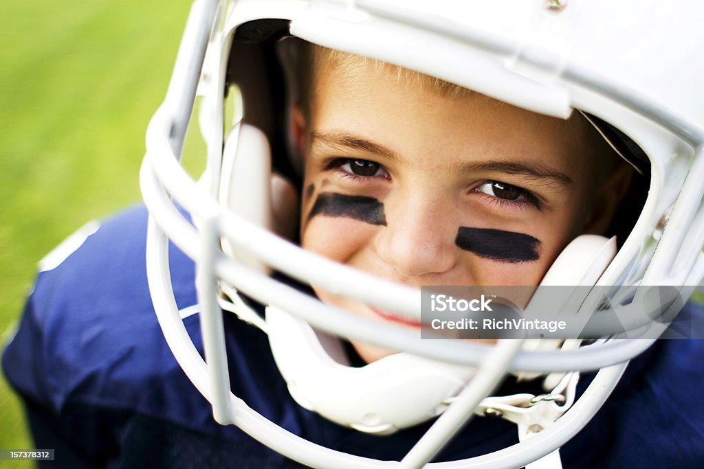 Young Football Player A young football player loves to play little league football.  American Football - Sport Stock Photo