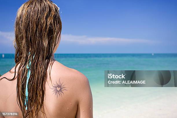 Girl Looking At Sea With Tattoo In The Back Stock Photo - Download Image Now - Heart Shape, Tattoo, Adult