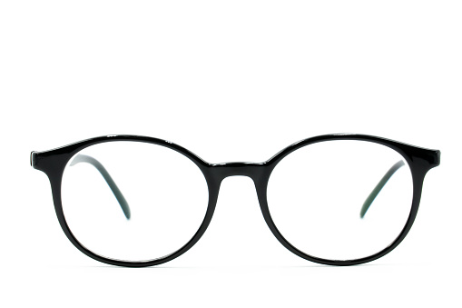 Round black-rimmed glasses are located frontally on a white background. Isolated.
