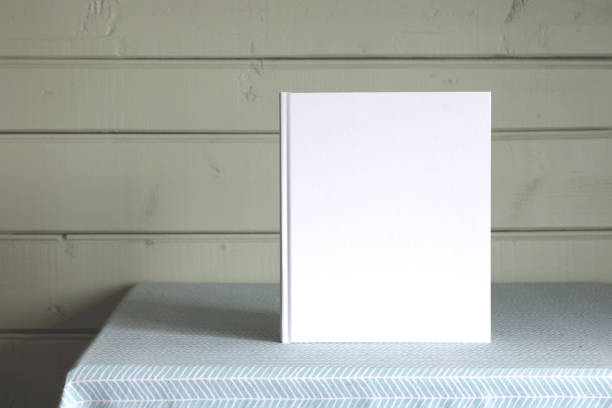 istock Mockup book. An album with an empty cover on the table. 1573785124