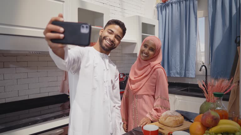 Happy couple from the emirates spending time in the kitchen